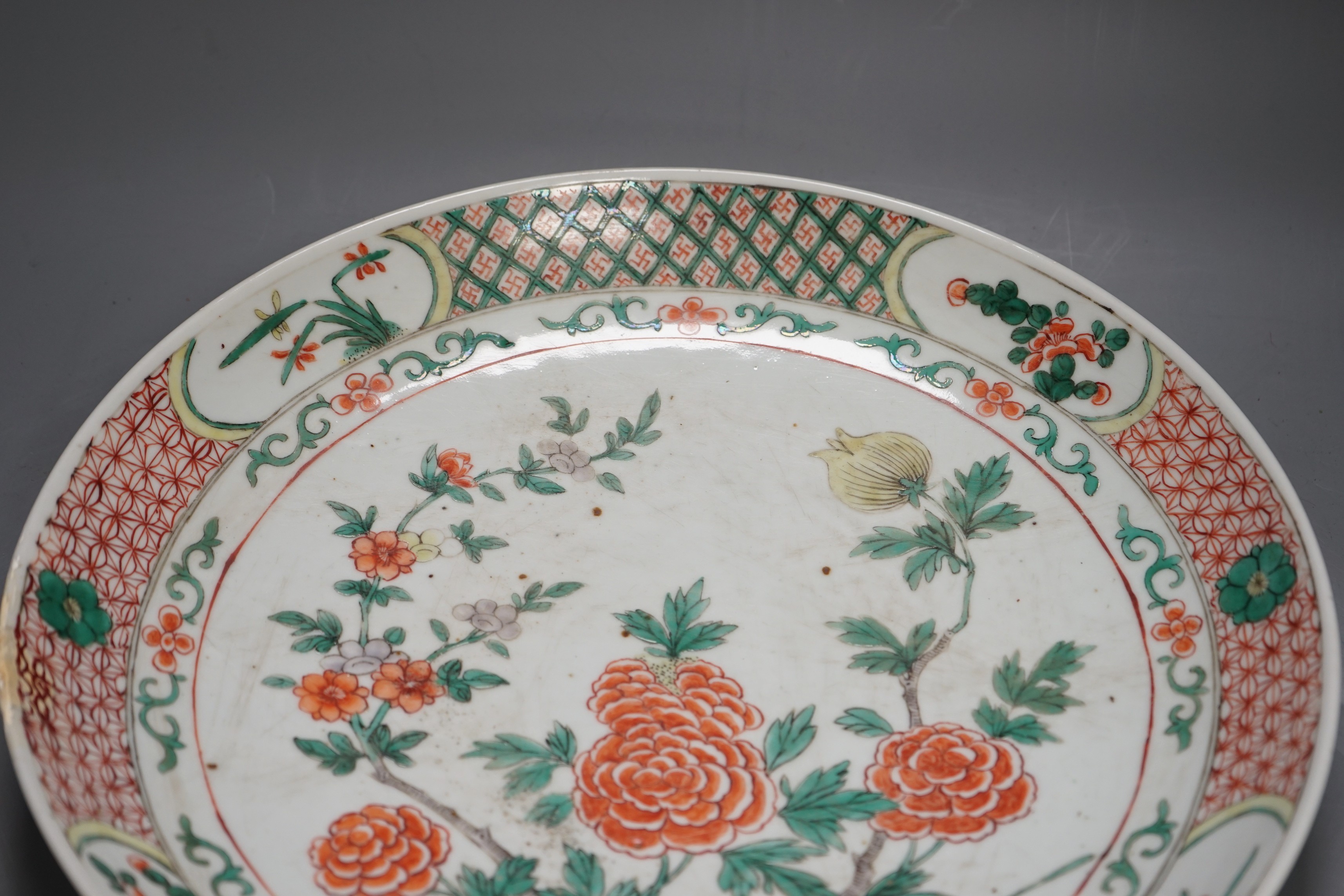 A large 19th century Chinese famille verte peony and dragon dish, 38.5cms diameter